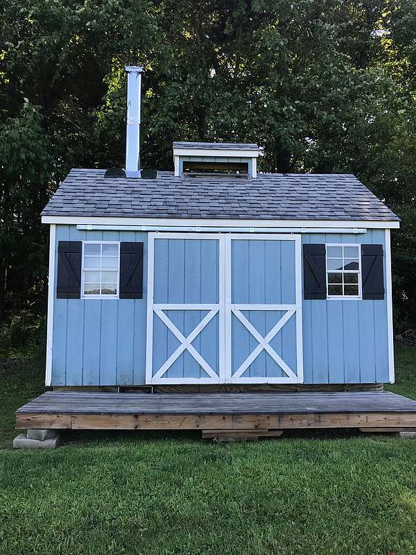 Small, blue sugar shack on the Laraway School campus. 