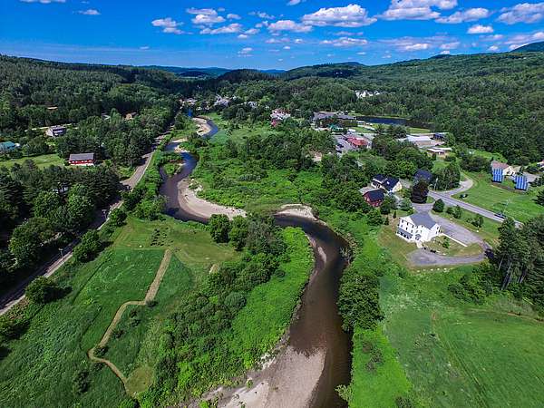 An aerial image of the Little River meandering through riparian area and agricultural fields. 