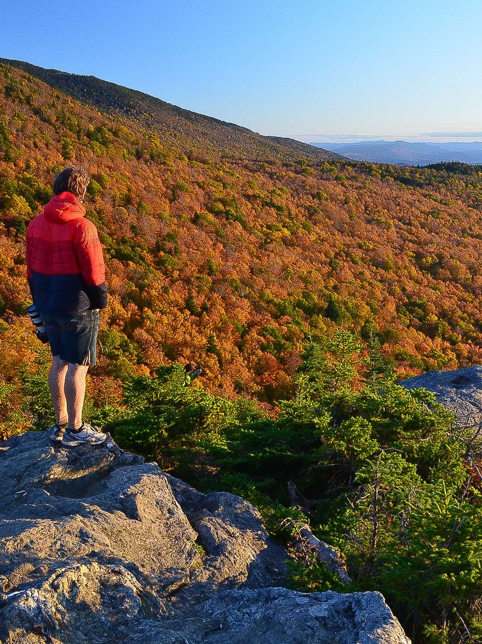 A hiker standing at a sweeping overlook