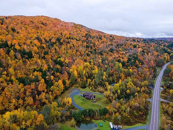 An aerial view showing the fall foliage of the protected property alongside Route 100. 