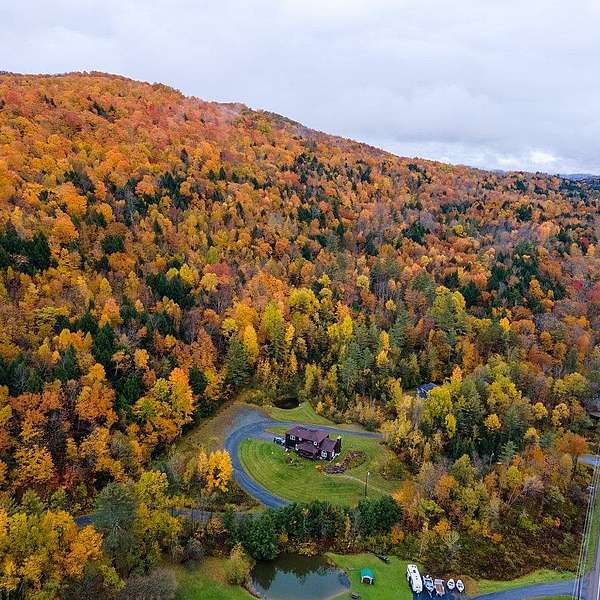 An aerial view showing the fall foliage of the protected property alongside Route 100. 